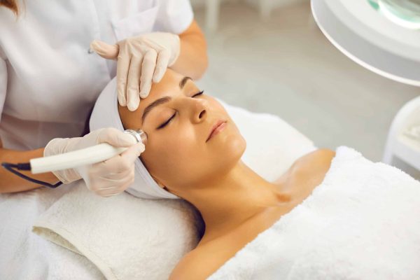 A lady getting treatment on skin by a device | Skincare In San Marcos, CA | Injex Aesthetics and Wellness